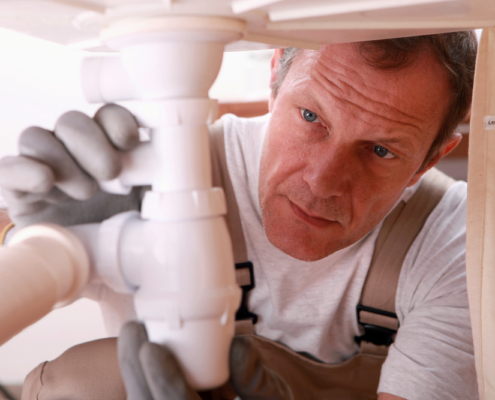 Man repairing sink for customer